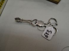 A pair of Georgian silver monogrammed 'E J' sugar nips with scallop terminals