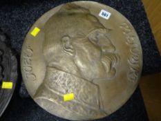 A believed bronze Eastern-European circular relief plaque portrait of a moustached gentleman in