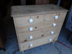 A stripped pine chest of drawers, two short above three long