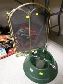 A modern plastic Christmas tree stand & a brass effect fireguard
