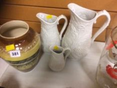 A set of Portmeirion Parian ware graduated jugs, signed by Angharad Menna together with a