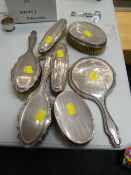 A seven-piece near-matching silver backed dressing table set