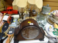 A polished mantel clock, a pair of table lamps in the form of sword handles & three clocks