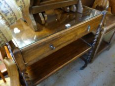 A vintage oak dinner trolley with cutlery drawer on wheels