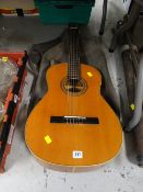 A Spanish acoustic guitar & sundry walking sticks, distressed telescope etc