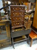 A small reproduction mahogany four-drawer chest, dark oak tea trolley & magazine rack