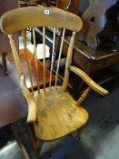 A pine Windsor-style kitchen armchair