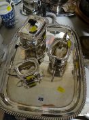 A three-piece EPNS tea service on a similar EPNS twin-handled tray