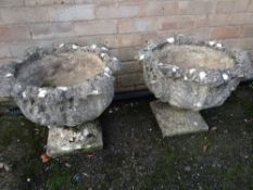 A pair of stone acanthus design low garden planters (outside)