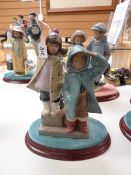 A Lladro model of two children apparently gazing out to sea with lantern