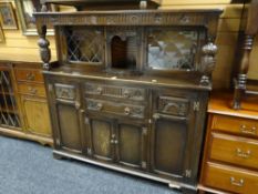 A carved Priory-style buffet sideboard