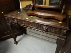 A nice antique carved oak side table with carved railback & single drawer