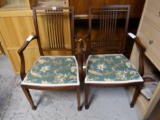 A pair of reproduction mahogany high back arm / carver dining chairs