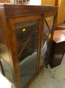 A vintage Deco-style two glass door dark wood display cabinet