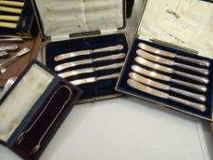 Two cased sets of silver-handled butter knives (one part-complete) together with a pair of silver