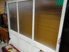 A frosted glass room-screen on castors