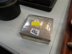 A silver cigarette box with contents including a pair of 9ct yellow gold cuff links