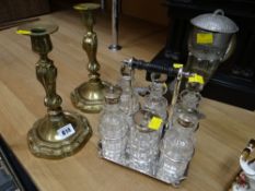 A pair of ornate brass candlestick holders, an EPNS six-bottle cruet set & a metal mounted horn