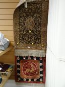 An intricately patterned prayer mat & another