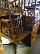 A vintage oak pullout extending dining table with barley-twist cross stretcher base together with