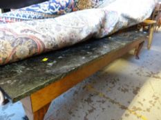 A long narrow green marble topped long John coffee table