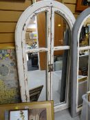 A painted wooden framed arch wall mirror