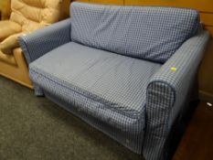 A blue checkered patterned bed settee