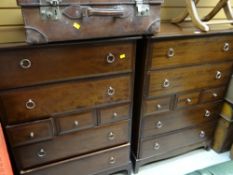 A suite of Stag bedroom furniture comprising two-door wardrobe, pair of matching tall chests of