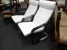 A pair of modern black painted wooden & upholstered armchairs