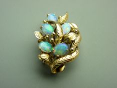 A FOURTEEN CARAT GOLD LEAF & FLORAL FOIL BACKED BROOCH having five oval cabochon opals, 6.7gms gross