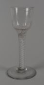 A MID-EIGHTEENTH CENTURY OPAQUE TWIST STEM DRINKING GLASS having a fluted funnel shaped bowl over