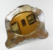 A LARGE SILVER FRAMED EASEL MIRROR with bevelled oval glass in a shaped frame, engraved with