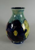 A MOORCROFT LIGHT & DEEP BLUE GROUND TUBE-LINED FLORAL VASE of baluster form with narrow slightly