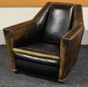 AN UNUSUAL STUDDED LEATHER ANTIQUE ARMCHAIR on bun feet with castors