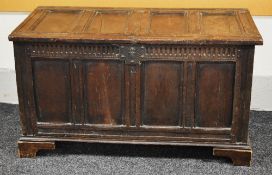 A LATE EIGHTEENTH CENTURY OAK BLANKET CHEST having a four panel facade and four panel hinged lid