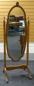 A BURR WALNUT CHEVAL MIRROR of oval shaped form within a cabriole acanthus carved frame, 175cms