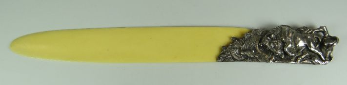 A SILVER HANDLED PAGE-TURNER in the form of a charging bull and snake in a naturalistic setting,