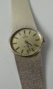AN OMEGA DE VILLE LADIES 9ct WHITE GOLD BRACELET WATCH having a textured tapering bracelet & oval