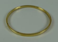 A 9ct YELLOW GOLD PLAIN FORM BANGLE, 10.5gms