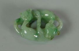 A CHINESE CARVED SPINACH JADE TOGGLE in the form of two fighting lions in opposition, 4cms long