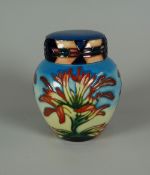 A YEAR 2000 MOORCROFT LIDDED GINGER JAR in the Indian Paintbrush pattern, 11cms high