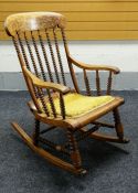 AN UNUSUAL NINETEENTH CENTURY ROCKING CHAIR having tapering turned bobbin back, sides &