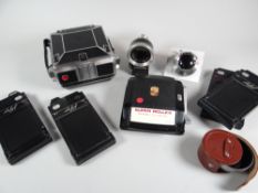 A RARE 1952 LINHOF TECHNICA QUARTER -PLATE CAMERA with original case, five glass plate-slides, two