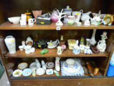 Large quantity of ornamental china, porcelain shoes, trinket boxes etc (on three shelves)