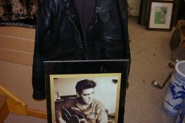 Framed poster of Elvis Presley in uniform with guitar and a leather jacket