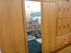 Modern light wood effect three piece bedroom suite of triple door wardrobe with central mirror, five