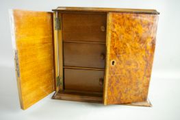 A VICTORIAN BURR WALNUT TABLE CABINET, the rectangular top with edge moulding over twin front