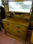 AN EDWARDIAN MAHOGANY DRESSING CHEST with two long and two short drawers having a tilting mirror