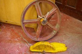 A CAST IRON WHEEL from a Dening hay side rack with cover