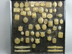 SHIRE/HEAVY HORSE BRASSWARE - a near 2ft square display board mounted with fifty plus saddler's